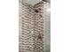 Close-up of a tiled shower with a glass door and bronze fixtures that adds elegance at 1700 Bassett St # 2216, Denver, CO 80202