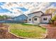 A lovely backyard featuring green grass, a patio, mulch beds, and a wood fence at 3339 Blue Grass Cir, Castle Rock, CO 80109