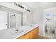 A spacious bathroom featuring double sinks, ample counter space, and a large mirror at 3339 Blue Grass Cir, Castle Rock, CO 80109