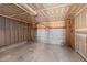 Spacious two-car garage with unfinished drywall and concrete flooring at 3339 Blue Grass Cir, Castle Rock, CO 80109