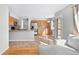 Open kitchen with stainless steel appliances, wooden cabinets, and a breakfast bar blends seamlessly with the living area at 3339 Blue Grass Cir, Castle Rock, CO 80109