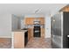 Updated kitchen with stainless steel appliances, tile floors, wooden cabinets, and ample counter space at 3339 Blue Grass Cir, Castle Rock, CO 80109