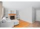 Bright living room features a fireplace, hardwood floors, built-in shelves, and a comfortable gray couch at 3339 Blue Grass Cir, Castle Rock, CO 80109
