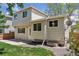 Beige home's exterior features a well-kept yard and a back entrance for convenience at 17611 Hoyt Pl, Parker, CO 80134