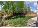 Well-maintained backyard with lush green grass, mature trees, play structure, and a privacy fence at 17611 Hoyt Pl, Parker, CO 80134