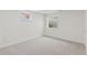 Finished basement features gray carpet, two windows, and base trim at 17611 Hoyt Pl, Parker, CO 80134