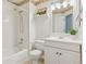 Bathroom features a shower/tub combination, decorative wall paper, and a large vanity with plant decor at 17611 Hoyt Pl, Parker, CO 80134