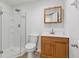 Updated bathroom with glass shower enclosure and wood vanity at 17611 Hoyt Pl, Parker, CO 80134