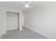 Bright bedroom featuring a ceiling fan, gray carpet, and a closet with an open door at 17611 Hoyt Pl, Parker, CO 80134