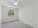 Bedroom featuring a ceiling fan, gray carpet, and a window with greenery at 17611 Hoyt Pl, Parker, CO 80134