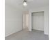 Bright bedroom featuring a ceiling fan, gray carpet, and a closet with an open door at 17611 Hoyt Pl, Parker, CO 80134