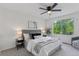 Bright bedroom boasts a large window, ceiling fan, and neutral décor at 17611 Hoyt Pl, Parker, CO 80134