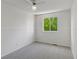 Empty bedroom with neutral carpet and a large window at 17611 Hoyt Pl, Parker, CO 80134
