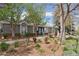 Inviting clubhouse featuring traditional architecture, mature trees, lush landscaping, and a calming blue sky at 17611 Hoyt Pl, Parker, CO 80134