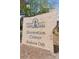 Stone sign that reads 'Clarke Farms Recreation Center Members Only' surrounded by mature landscaping and bright blue sky at 17611 Hoyt Pl, Parker, CO 80134
