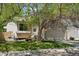 Charming home featuring a two-car garage, quaint front yard, and mature trees providing ample shade at 17611 Hoyt Pl, Parker, CO 80134