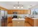 Well-lit kitchen with stainless steel appliances, center island, and ample wood cabinetry at 17611 Hoyt Pl, Parker, CO 80134
