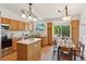 Eat-in kitchen with stainless steel appliances, wood cabinets, and bright window over the sink at 17611 Hoyt Pl, Parker, CO 80134