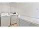 Laundry room featuring washer, dryer, cabinets and tile floors at 17611 Hoyt Pl, Parker, CO 80134