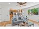 Open concept living room with hardwood floors, a gray sofa, and an attached kitchen at 17611 Hoyt Pl, Parker, CO 80134