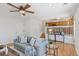 Open concept living room with hardwood floors, a gray sofa, and an attached kitchen at 17611 Hoyt Pl, Parker, CO 80134
