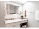 Bright bathroom features elegant marble countertop and decorative accents at 3004 S Niagara Way, Denver, CO 80224