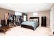 Cozy bedroom featuring a walk-in closet, neutral colors, carpeted floors, and a comfy bed with pillows at 3004 S Niagara Way, Denver, CO 80224