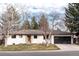 Charming single-story home featuring a well-maintained lawn and an attached two-car garage at 3004 S Niagara Way, Denver, CO 80224