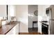 Well-lit kitchen featuring butcher block countertops, stainless steel sink and stainless appliances at 3004 S Niagara Way, Denver, CO 80224
