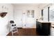 Airy kitchen featuring white cabinetry, a black island, and a view to the backyard at 3004 S Niagara Way, Denver, CO 80224