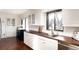 Bright kitchen with white cabinets, butcher block countertops, and stainless steel appliances at 3004 S Niagara Way, Denver, CO 80224