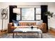 Comfortable living room with a leather sofa, stylish rug, and plenty of natural light at 3004 S Niagara Way, Denver, CO 80224