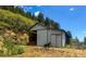 Large barn with open door at 20951 Pleasant Park Rd, Conifer, CO 80433