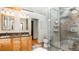Bathroom featuring double vanities, walk-in shower and custom stone tile at 20951 Pleasant Park Rd, Conifer, CO 80433
