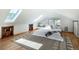 Bright bedroom with hardwood floors, built-in shelving, and skylights for ample natural light at 20951 Pleasant Park Rd, Conifer, CO 80433