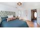 Comfortable bedroom with hardwood floors, natural light, and stylish headboard at 20951 Pleasant Park Rd, Conifer, CO 80433