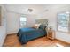Cozy bedroom with hardwood floors, natural light, and comfortable furnishings at 20951 Pleasant Park Rd, Conifer, CO 80433
