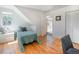 Bright bedroom with sloped ceilings, hardwood floors, and natural light at 20951 Pleasant Park Rd, Conifer, CO 80433
