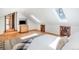 Comfortable bedroom featuring hardwood floors, built-in shelving, and sunny skylights at 20951 Pleasant Park Rd, Conifer, CO 80433