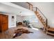 Spacious bonus room with natural wood staircase and wood laminate floors at 20951 Pleasant Park Rd, Conifer, CO 80433