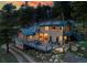 A beautiful exterior view of the house featuring a deck and lovely landscaping at 20951 Pleasant Park Rd, Conifer, CO 80433