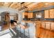 Charming kitchen with wood ceiling, island with seating, wood cabinets, and stainless steel appliances at 20951 Pleasant Park Rd, Conifer, CO 80433