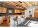 Charming kitchen with wood cabinets, island with seating, stainless steel appliances, and tiled floors at 20951 Pleasant Park Rd, Conifer, CO 80433