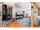 Inviting living room with a stone fireplace, wood accents, and cozy seating area at 20951 Pleasant Park Rd, Conifer, CO 80433