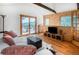 Bright living room featuring hardwood floors, mountain views, and comfortable furnishings at 20951 Pleasant Park Rd, Conifer, CO 80433
