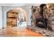 Comfortable living room with rock fireplace transitioning into the open kitchen at 20951 Pleasant Park Rd, Conifer, CO 80433