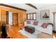 Inviting living room featuring wood paneling, hardwood floors, and comfortable furnishings at 20951 Pleasant Park Rd, Conifer, CO 80433