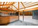 View inside horse stables with wooden dividers and metal bars at 20951 Pleasant Park Rd, Conifer, CO 80433