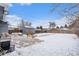 Large backyard with snow-covered ground and storage shed at 1280 Macon St, Aurora, CO 80010