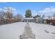 Snowy backyard with a view of the house and shed at 1280 Macon St, Aurora, CO 80010